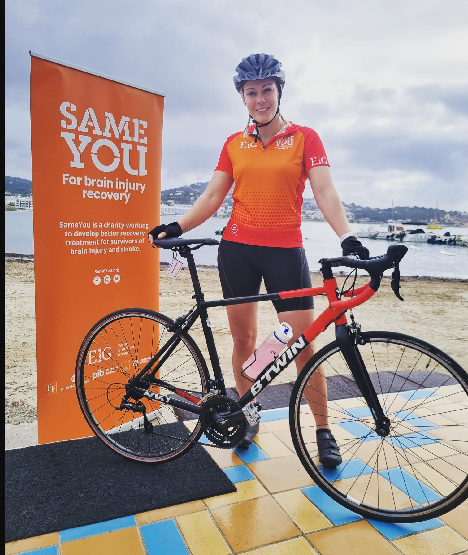Hannah standing with her bike at the cycling event