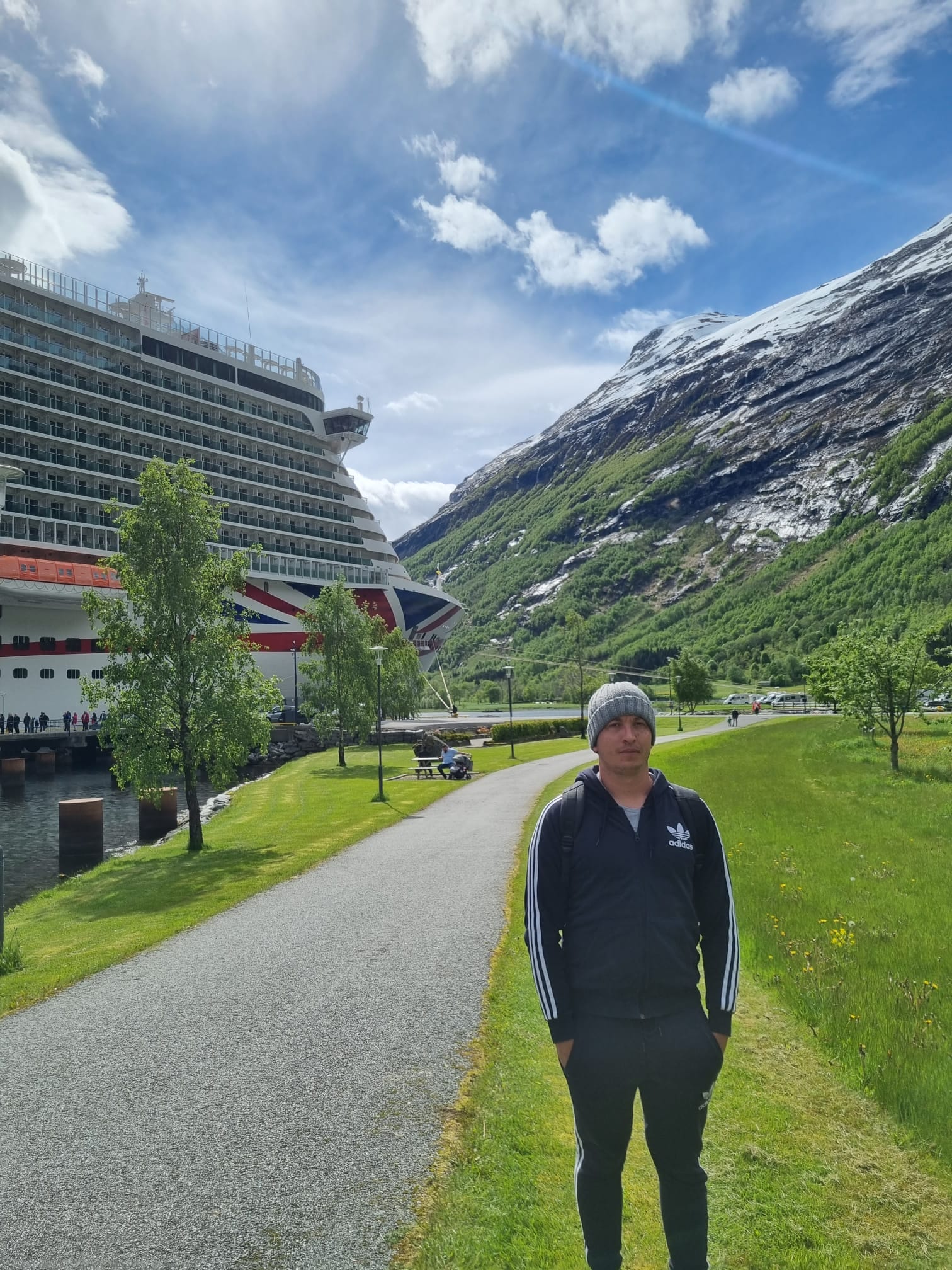 Chris standing in from of a cruise boat